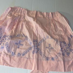Handmade pink apron with blue embroidered designs